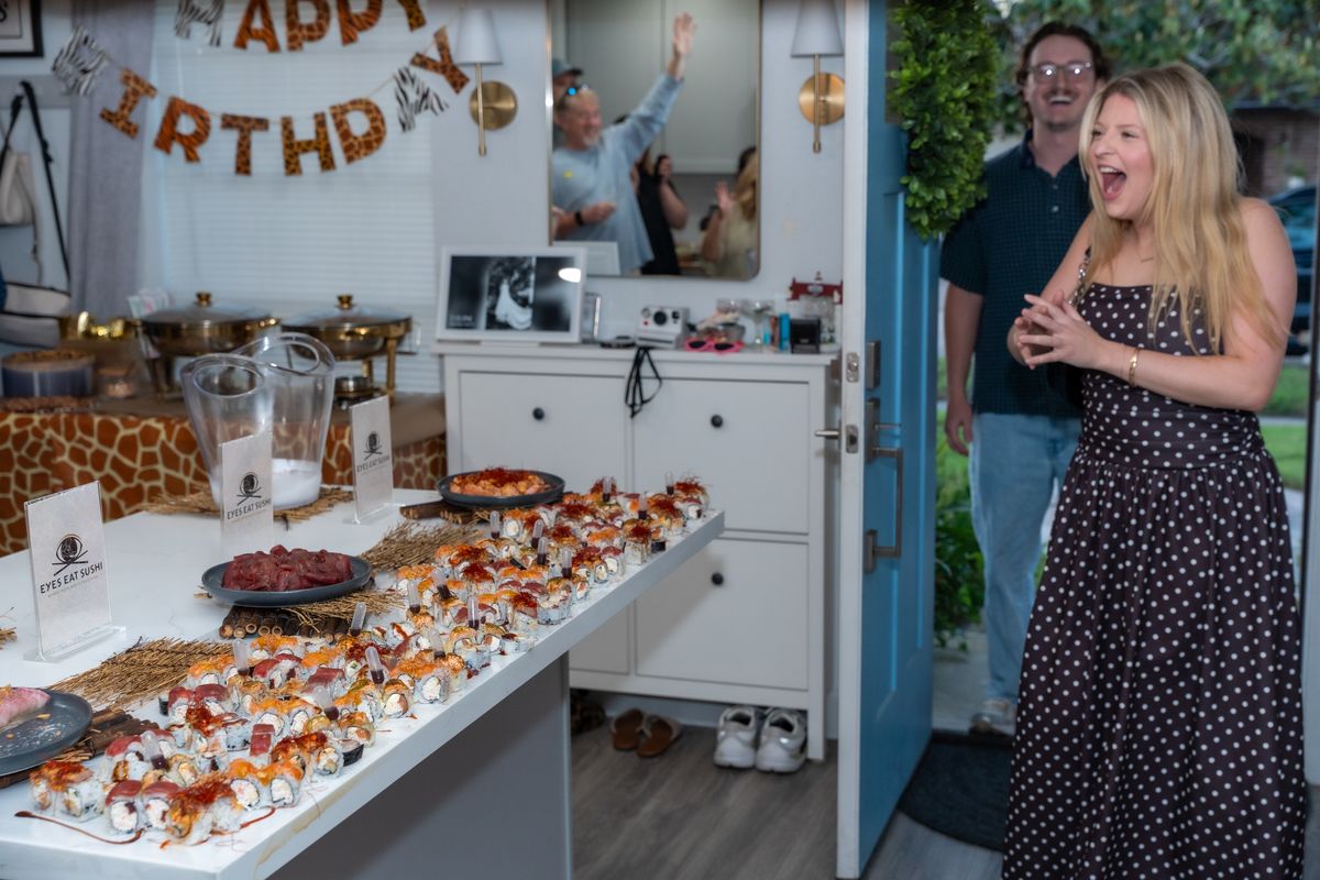 A birthday guest reacting with delight at the door.