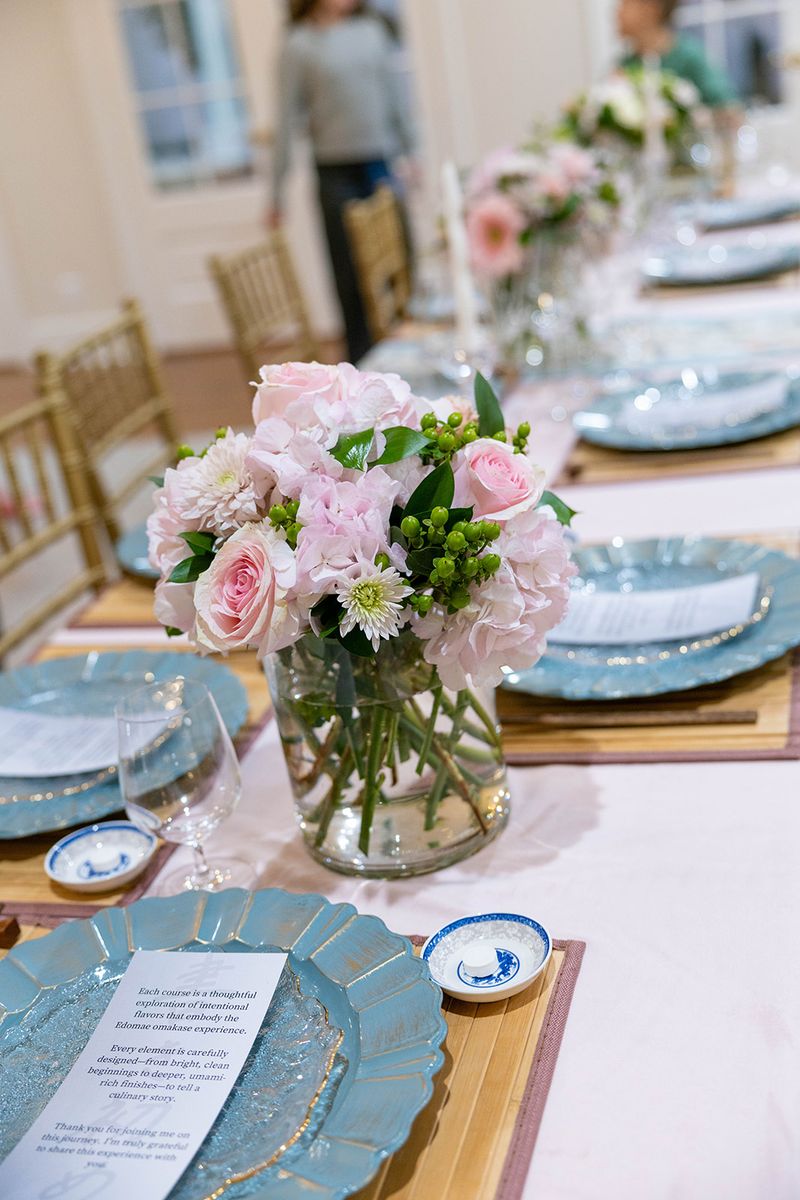 A floral table setting prepared before the first course.