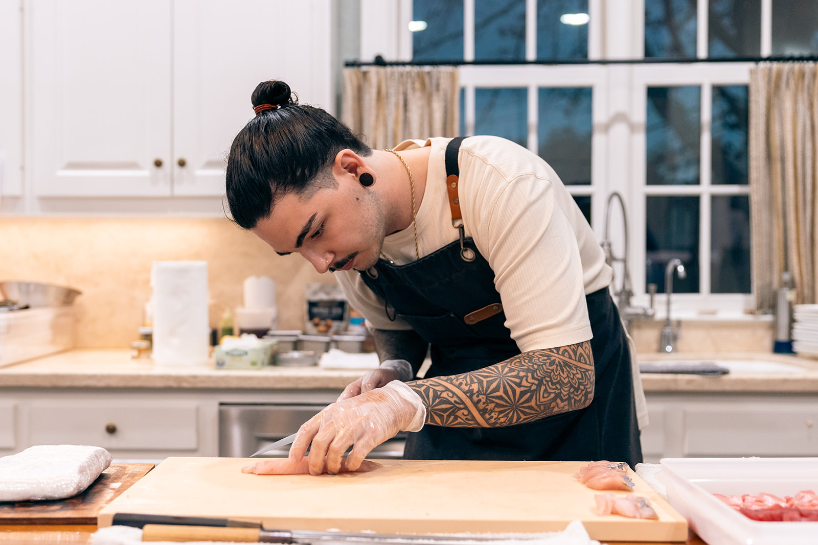Chef Logan preparing sushi during a private dining experience.