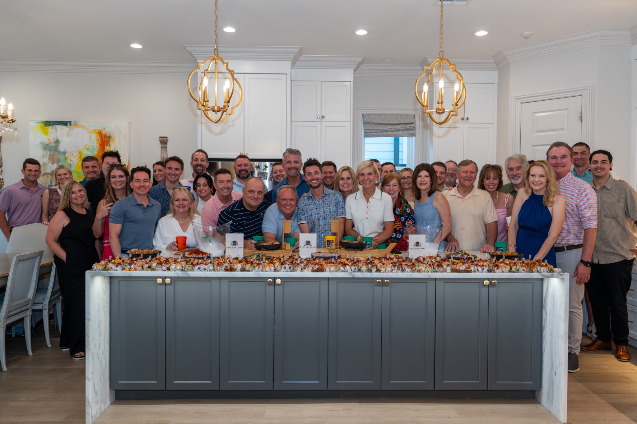 Guests gathered around a large private sushi spread.